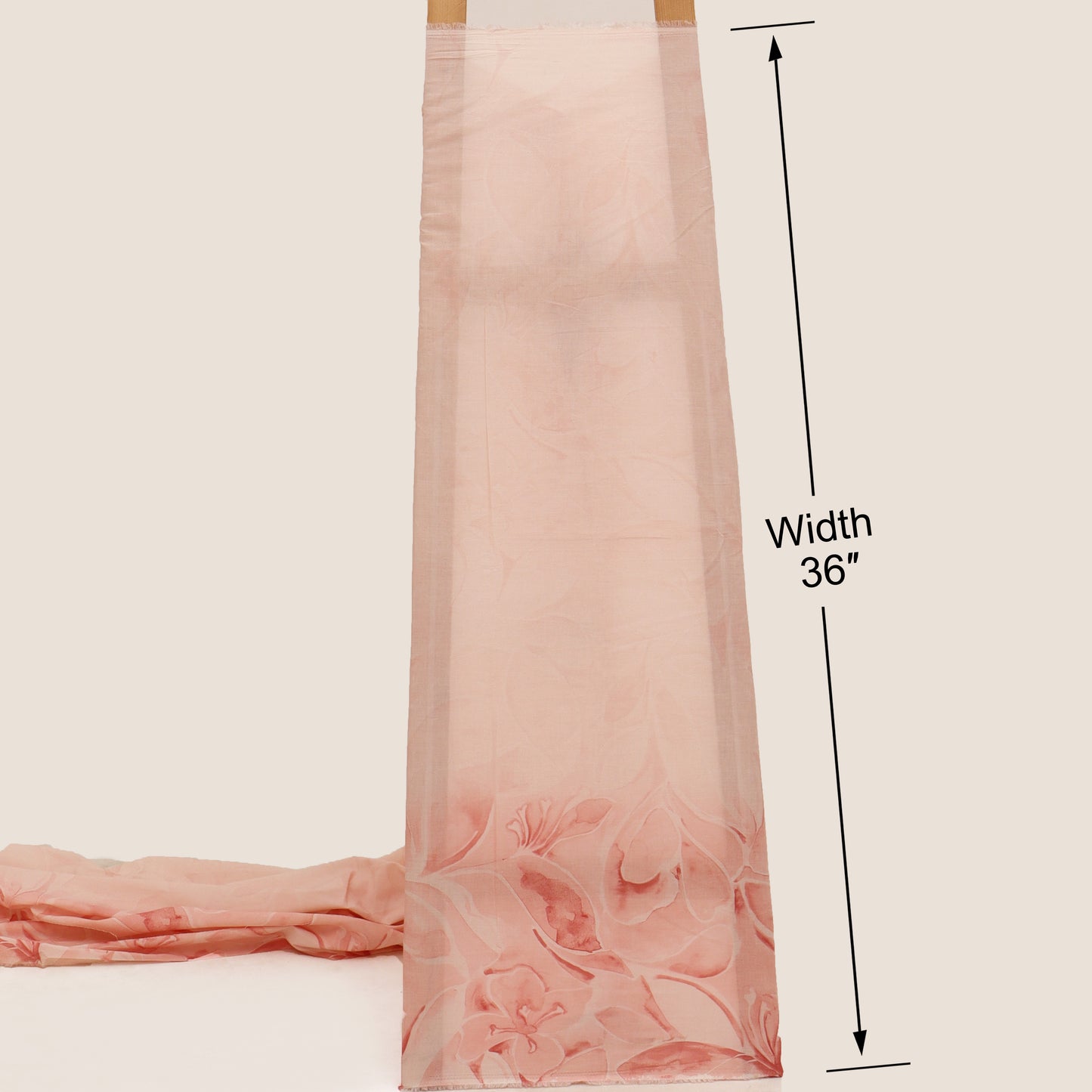 Pink fabric with floral pattern and measurement details on a beige background