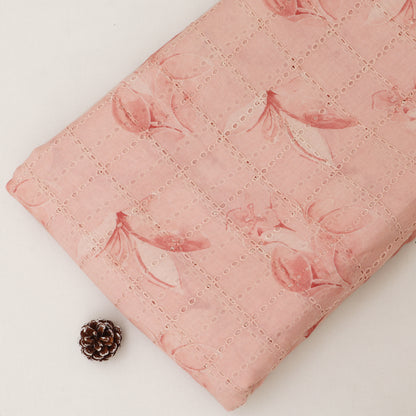 Pink quilt with floral pattern on a white background