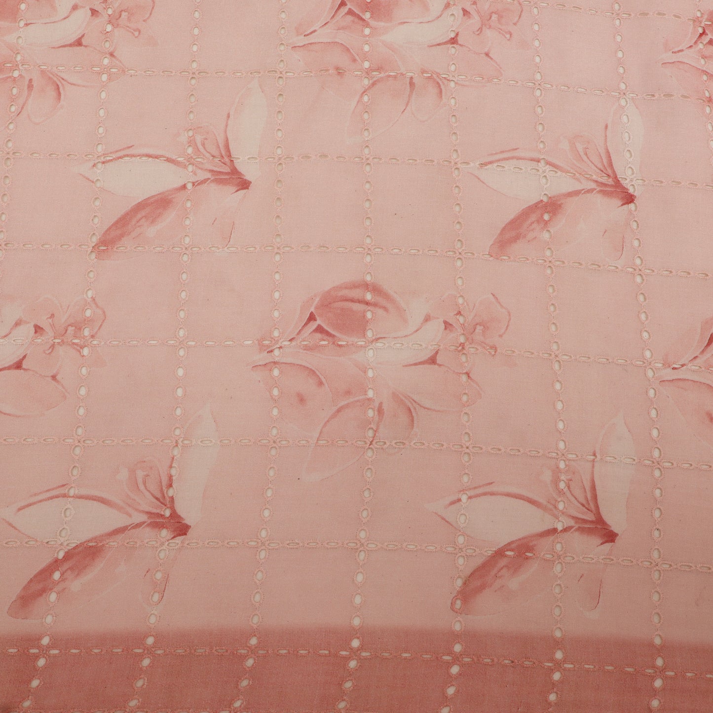 Quilted fabric with floral pattern on a pink background