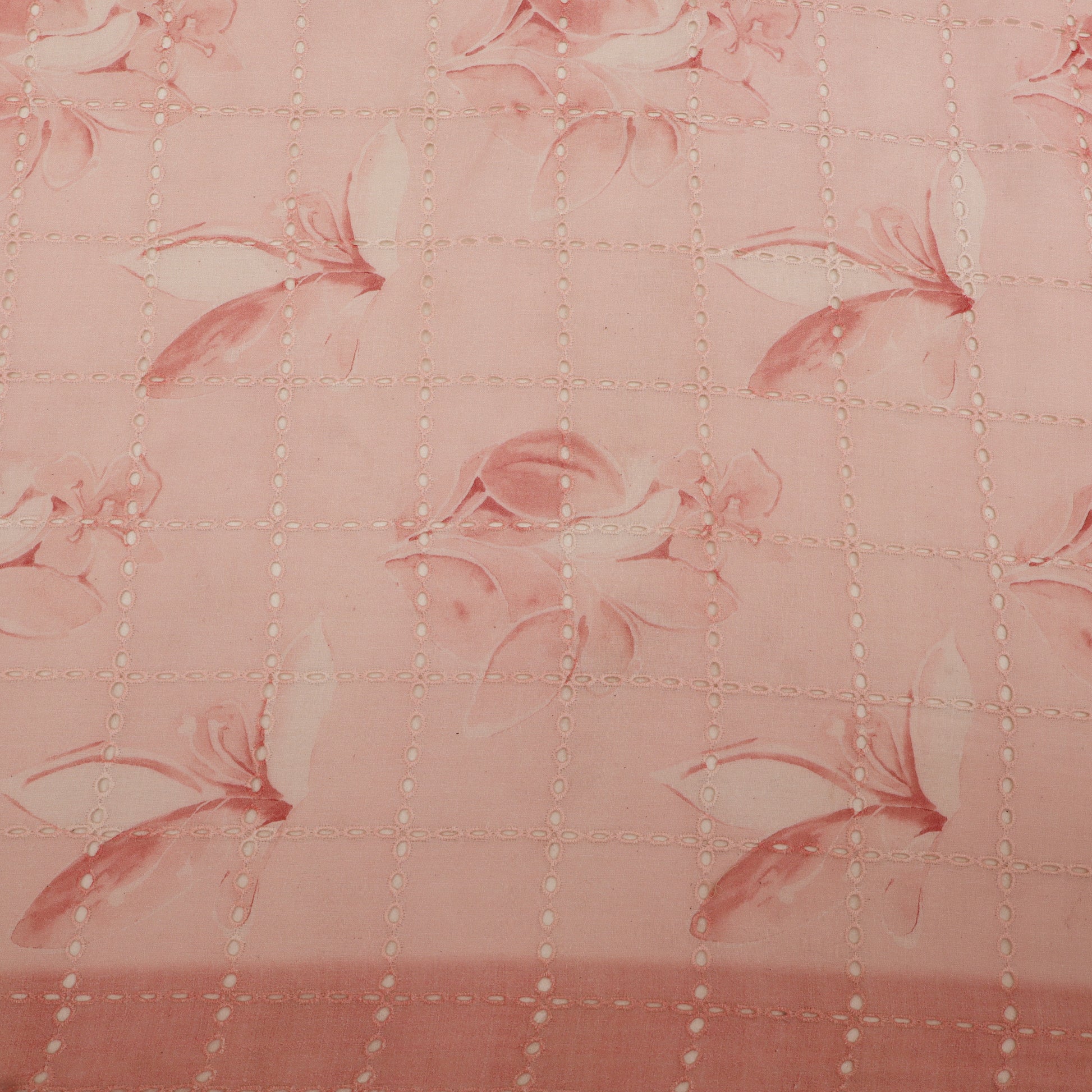 Quilted fabric with floral pattern on a pink background