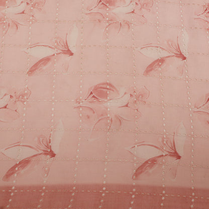 Quilted fabric with floral pattern on a pink background