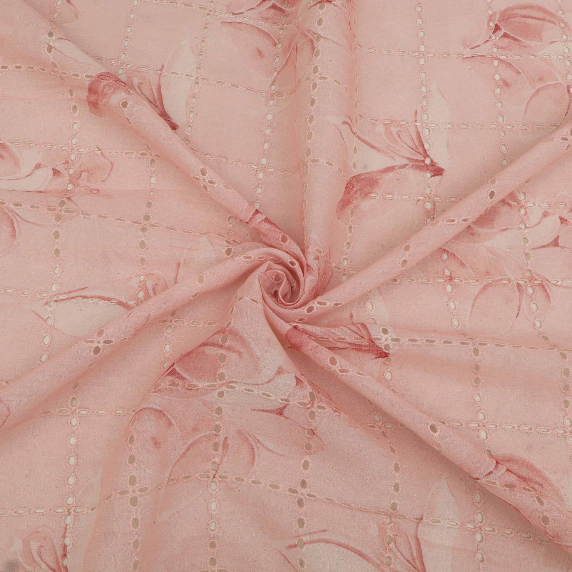 Close-up of pink fabric with floral patterns and stitching details