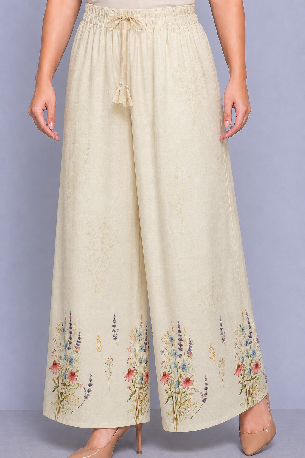 Beige wide-leg pants with floral embroidery on a plain background
