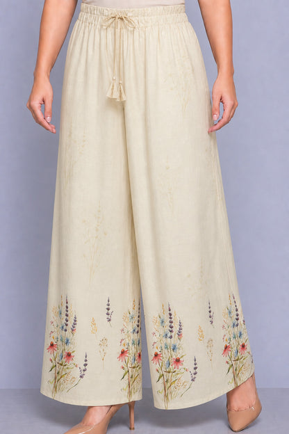 Beige wide-leg pants with floral embroidery on a plain background