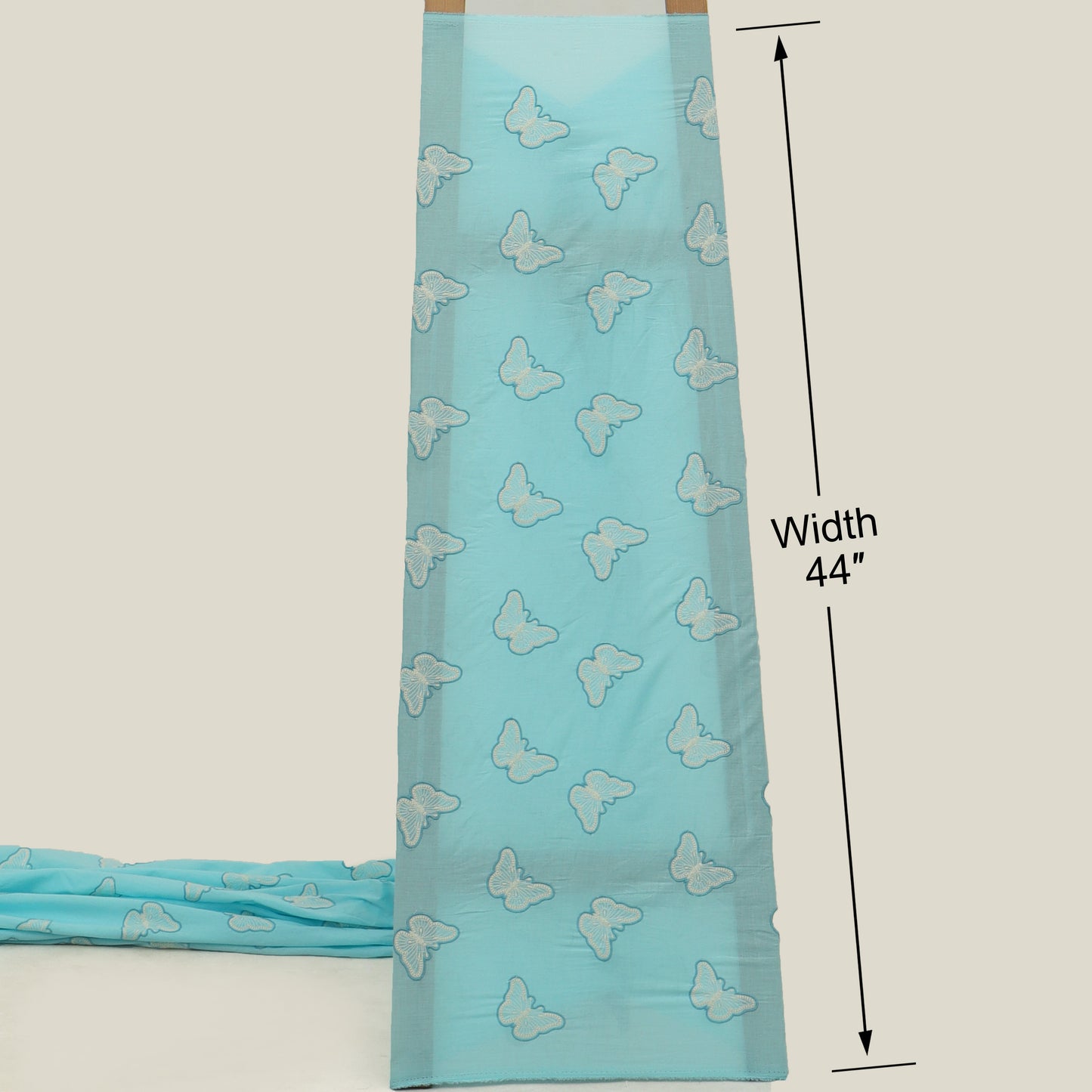 Turquoise fabric with butterfly patterns and measurements on a white background