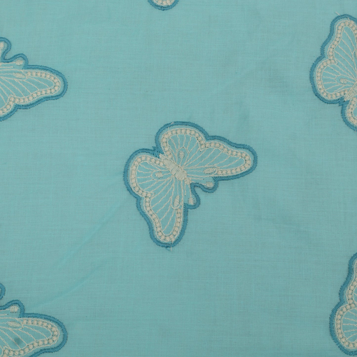 Butterfly patterns on a blue fabric background