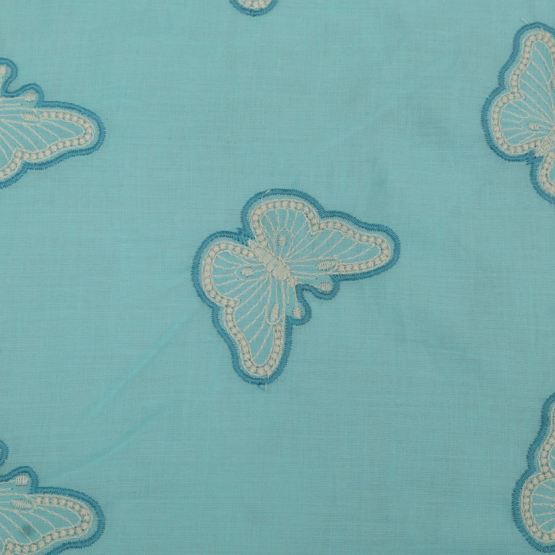 Butterfly patterns on a blue fabric background
