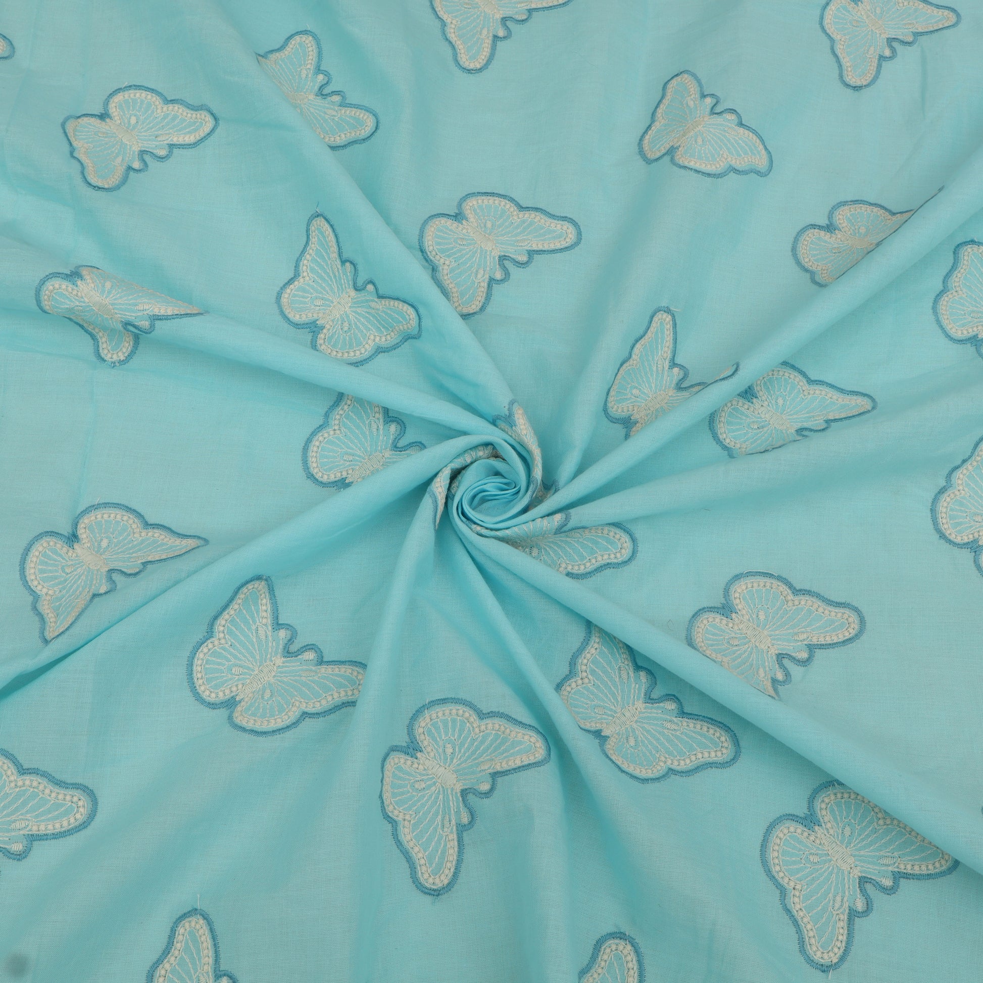 Turquoise fabric with embroidered white butterflies