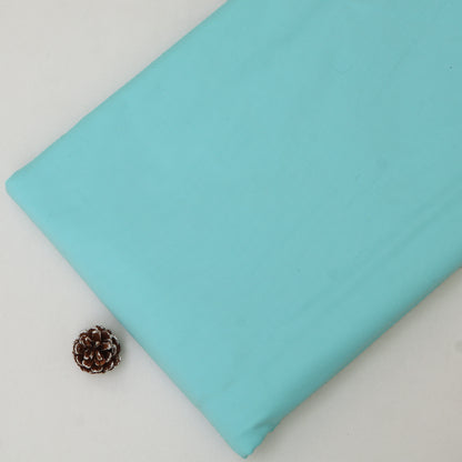 Light blue fabric with a pine cone on a white background