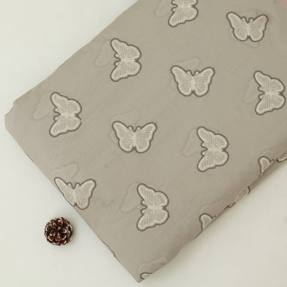 Fabric with butterfly pattern on a beige background