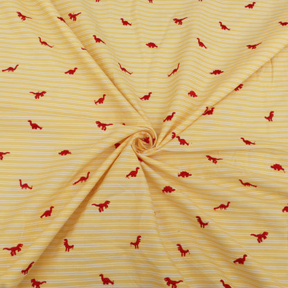 Yellow fabric with red dinosaur patterns