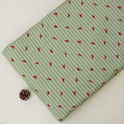 Green fabric with red pattern on a white background
