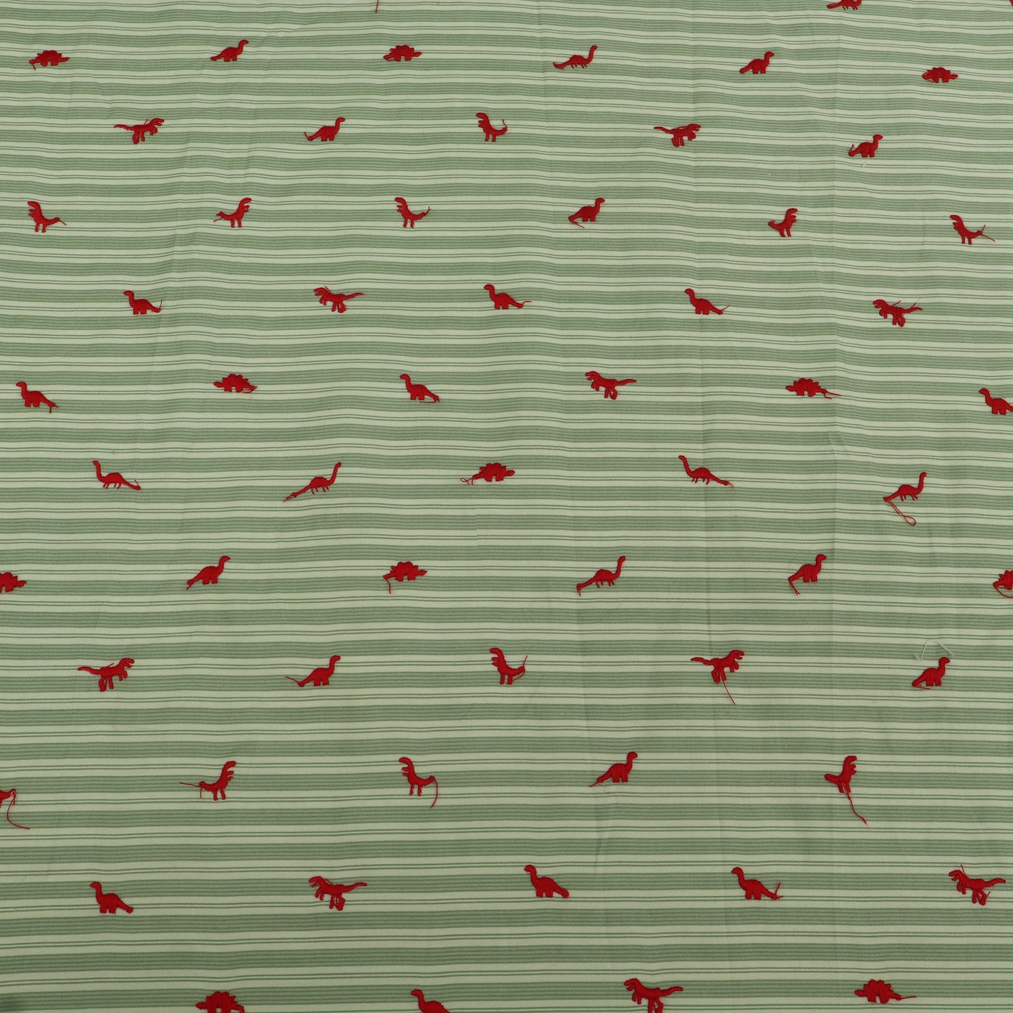 Pattern of red dinosaurs on a green striped background