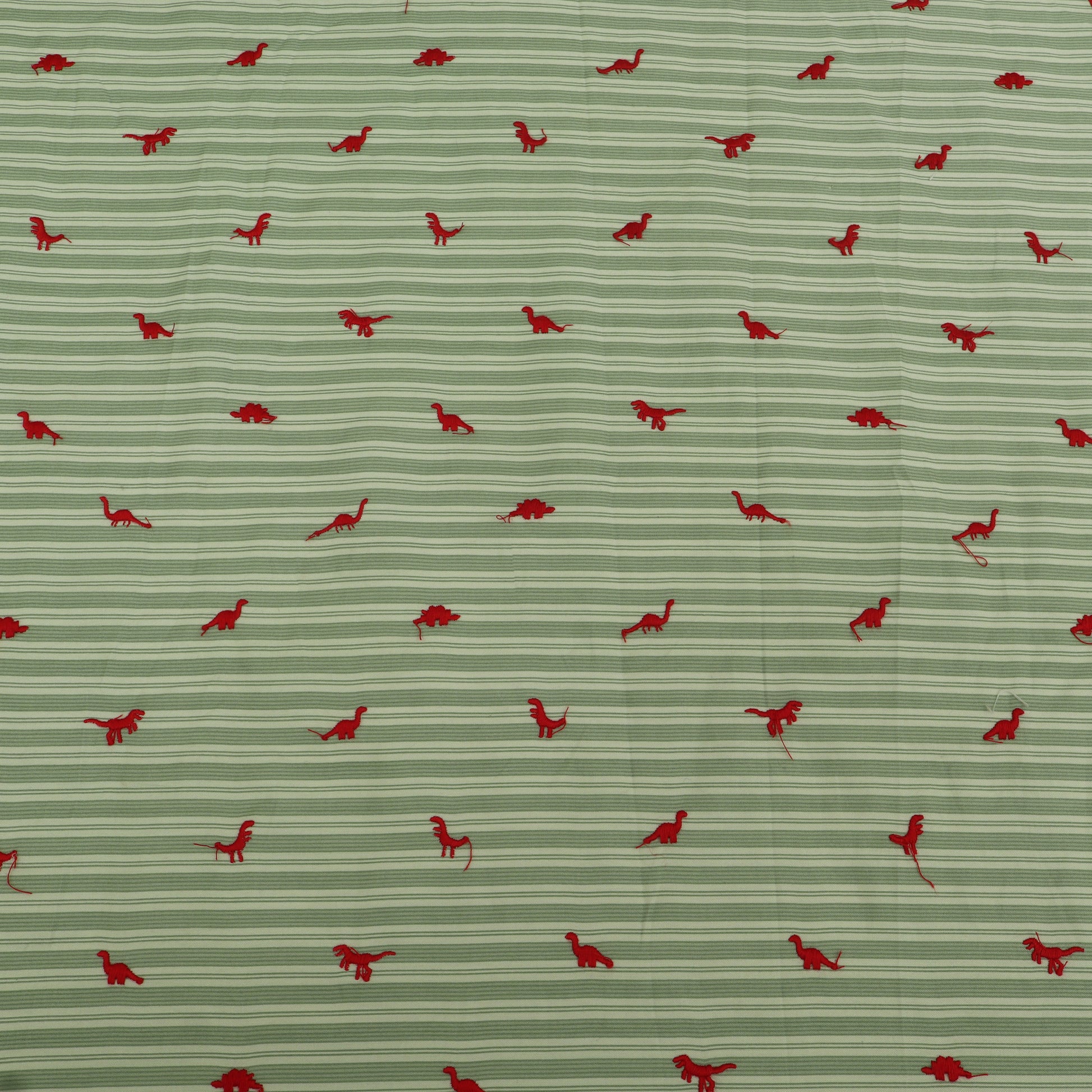 Pattern of red dinosaurs on a green striped background