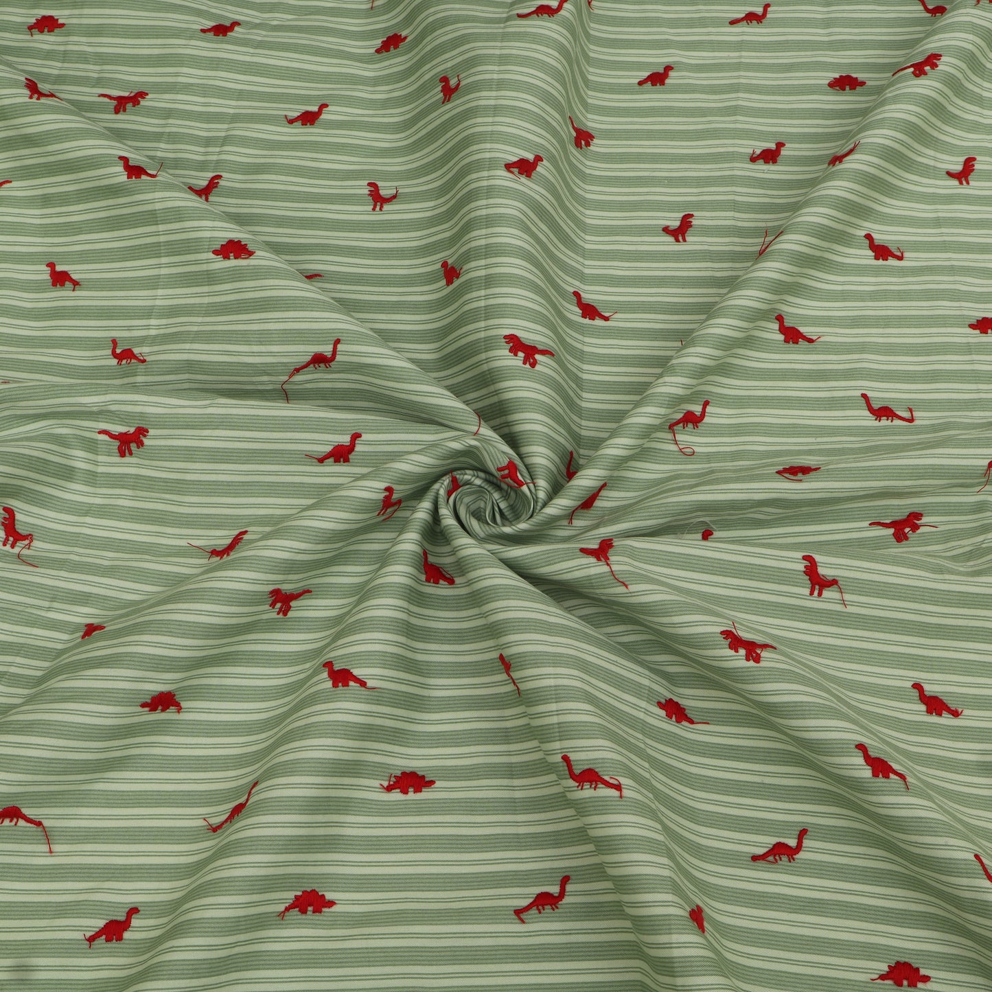 Green fabric with red dinosaur pattern