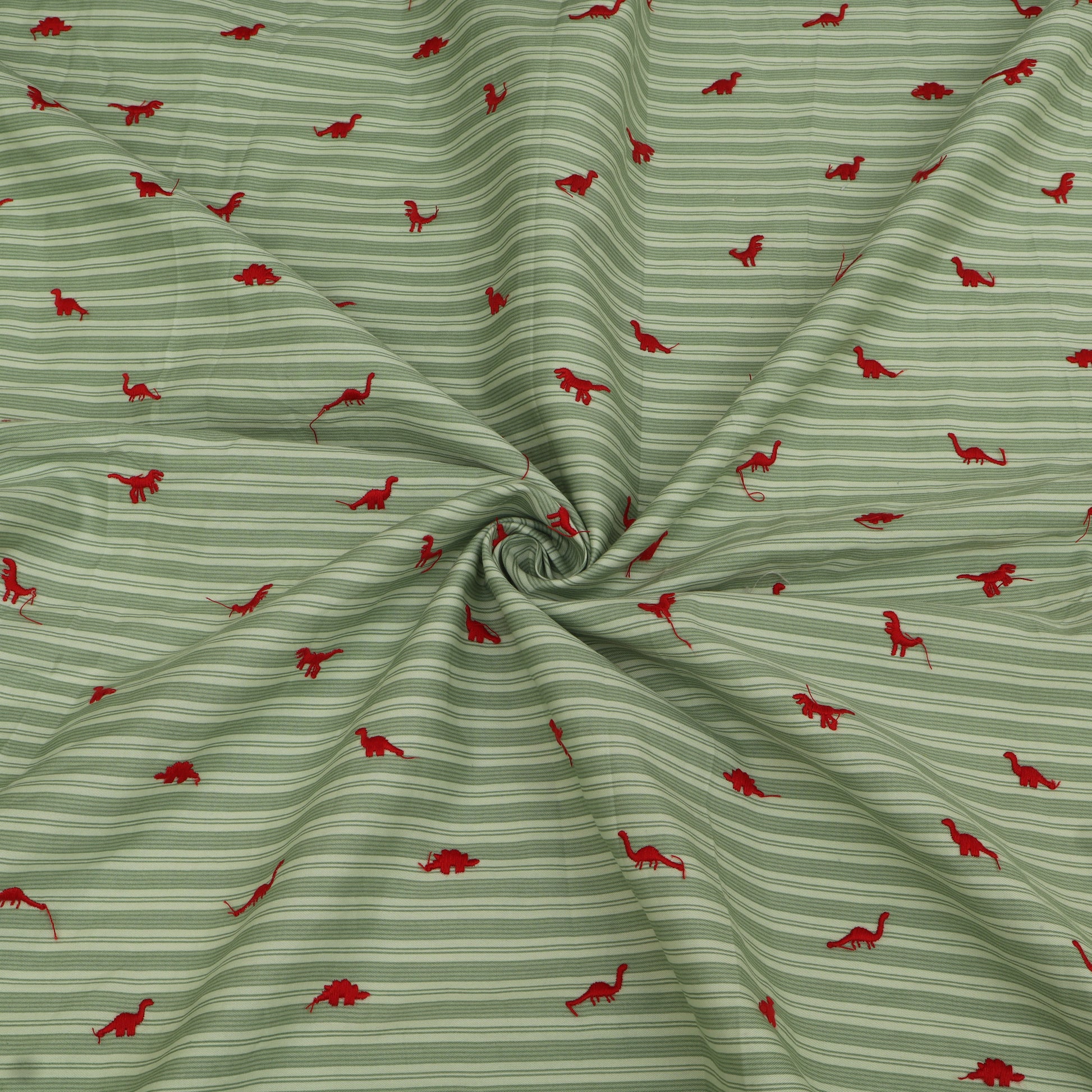Green fabric with red dinosaur pattern