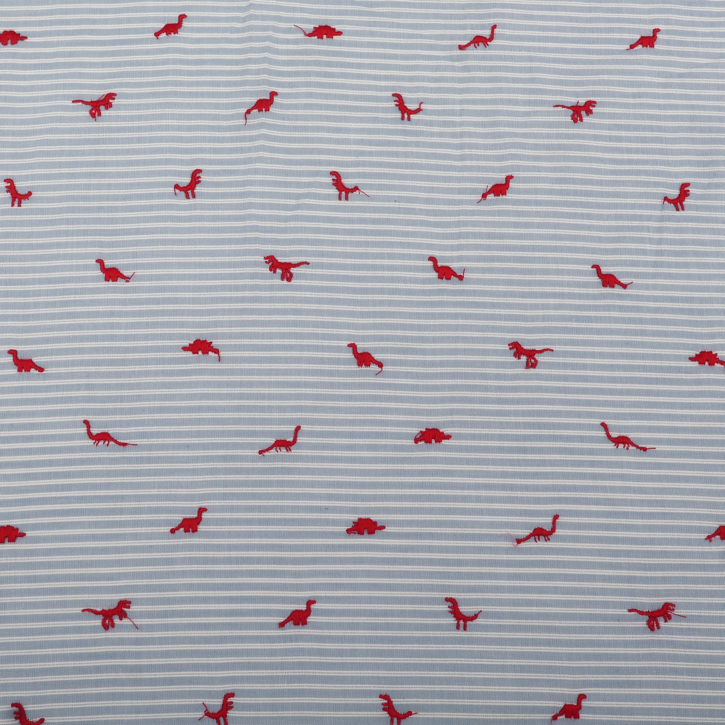 Pattern of red dinosaurs on a blue striped background