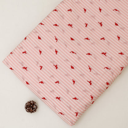 Pink fabric with red patterns on a white background