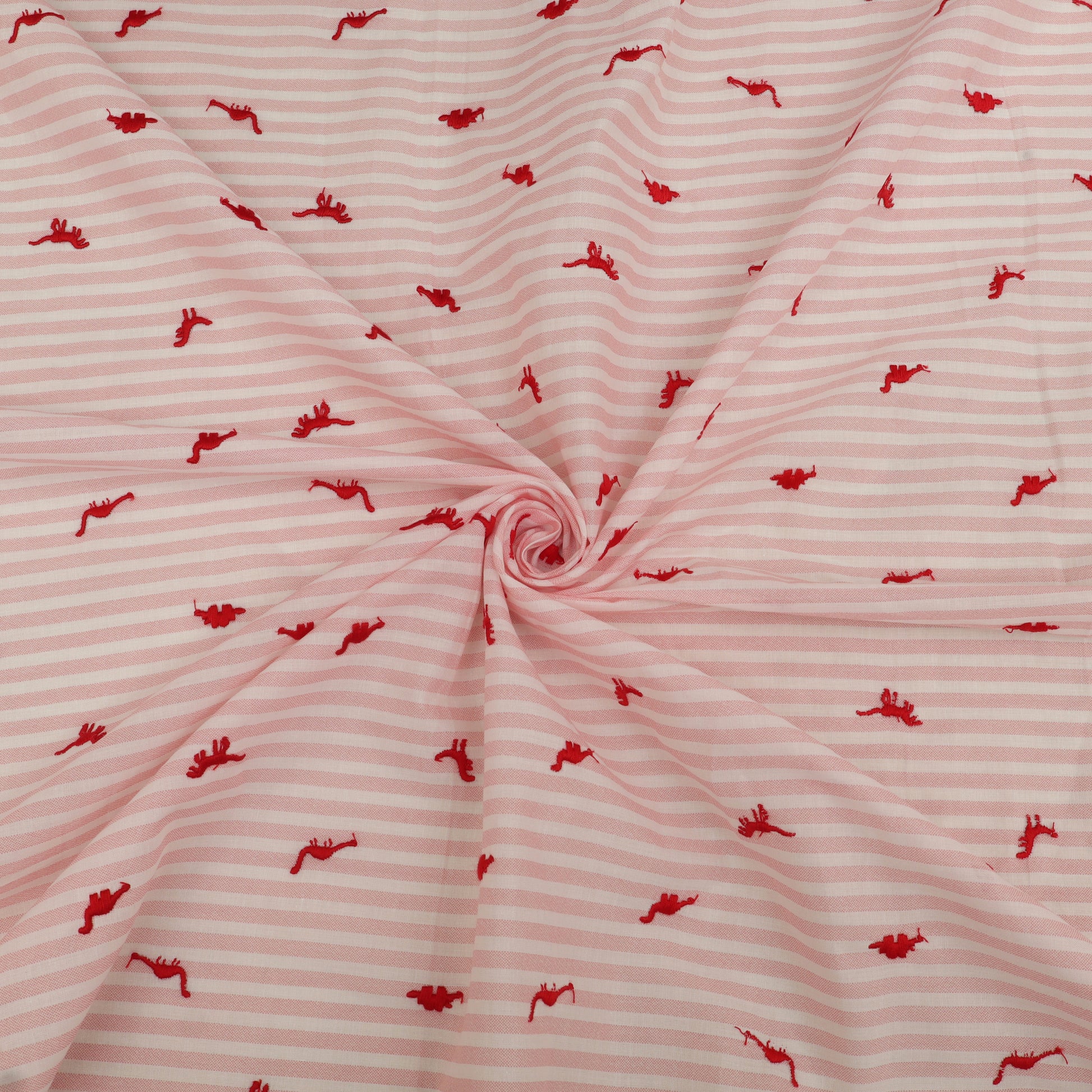 Pink fabric with red pattern, possibly of a child's garment