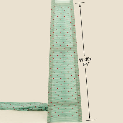 Green fabric with red pattern and measurement label on a beige background