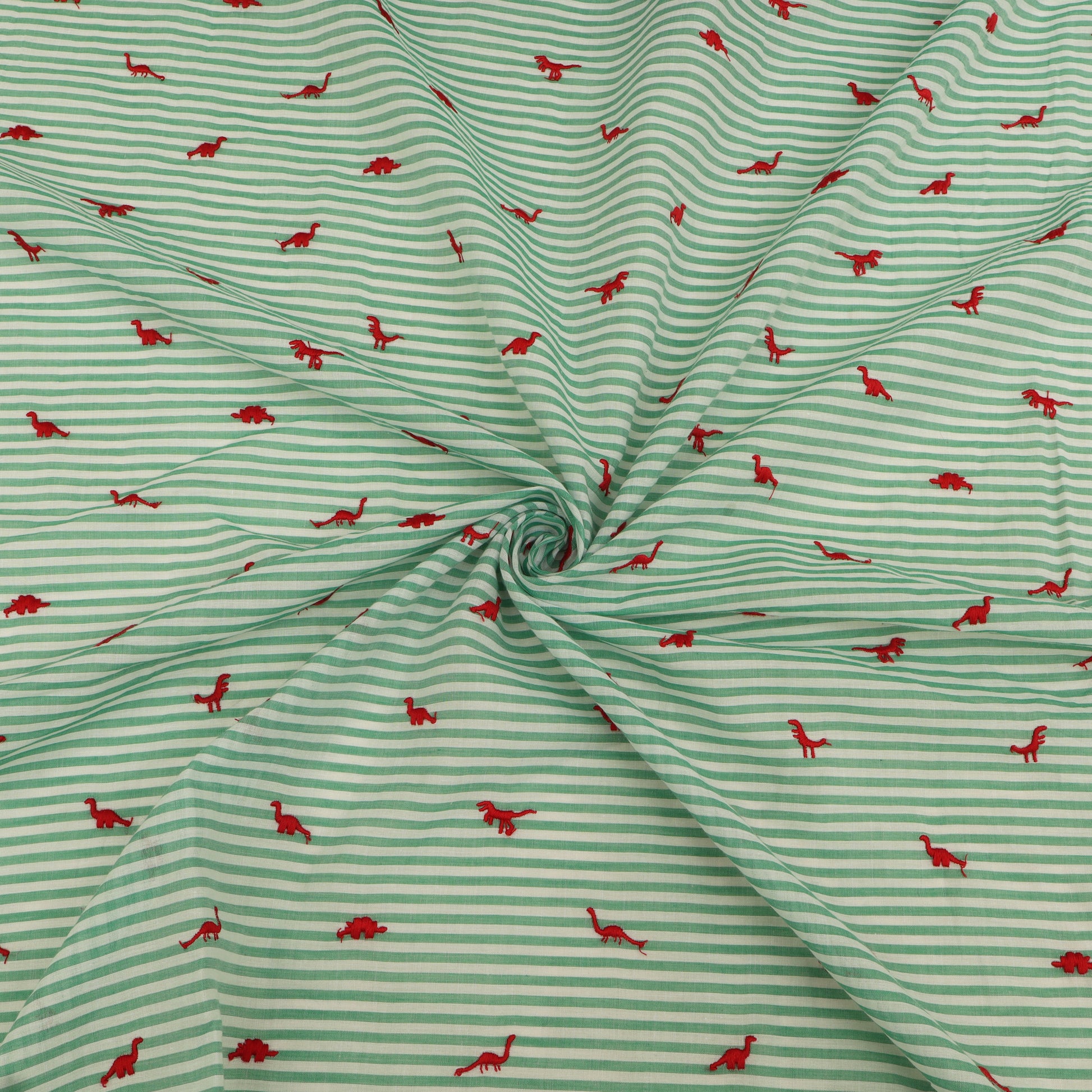 Green and white striped fabric with red dinosaur patterns