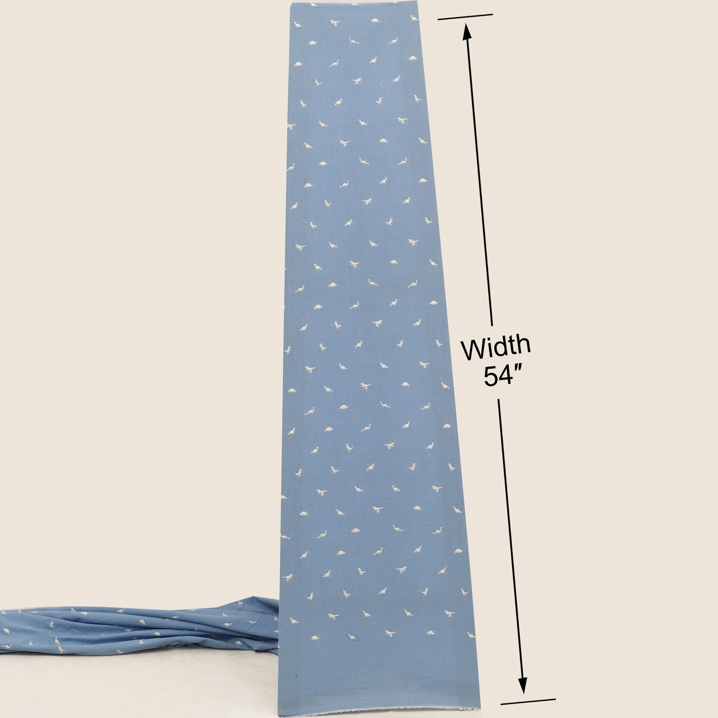 Blue fabric strip with white patterns and measurement label on a beige background