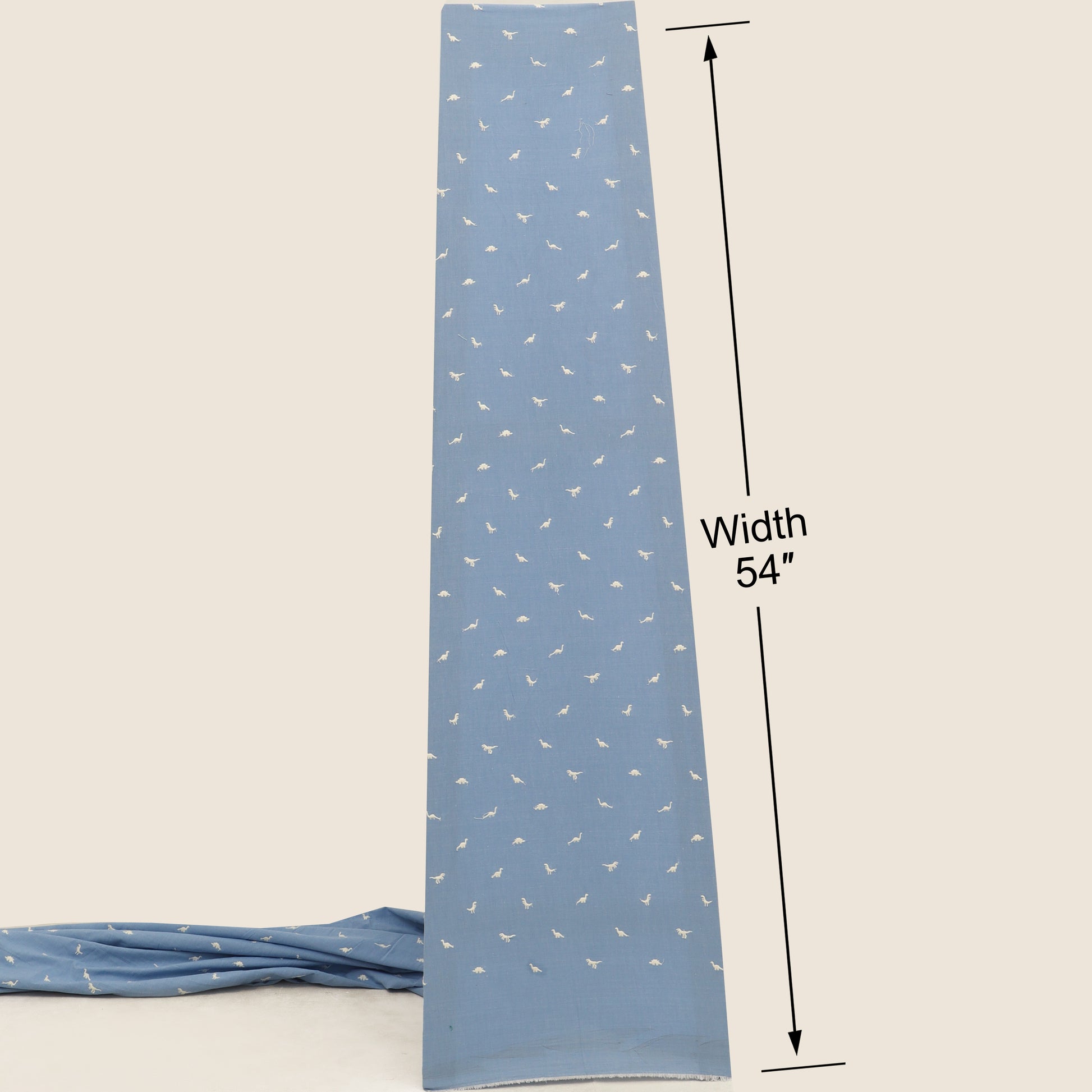 Blue fabric strip with white patterns and measurement label on a beige background