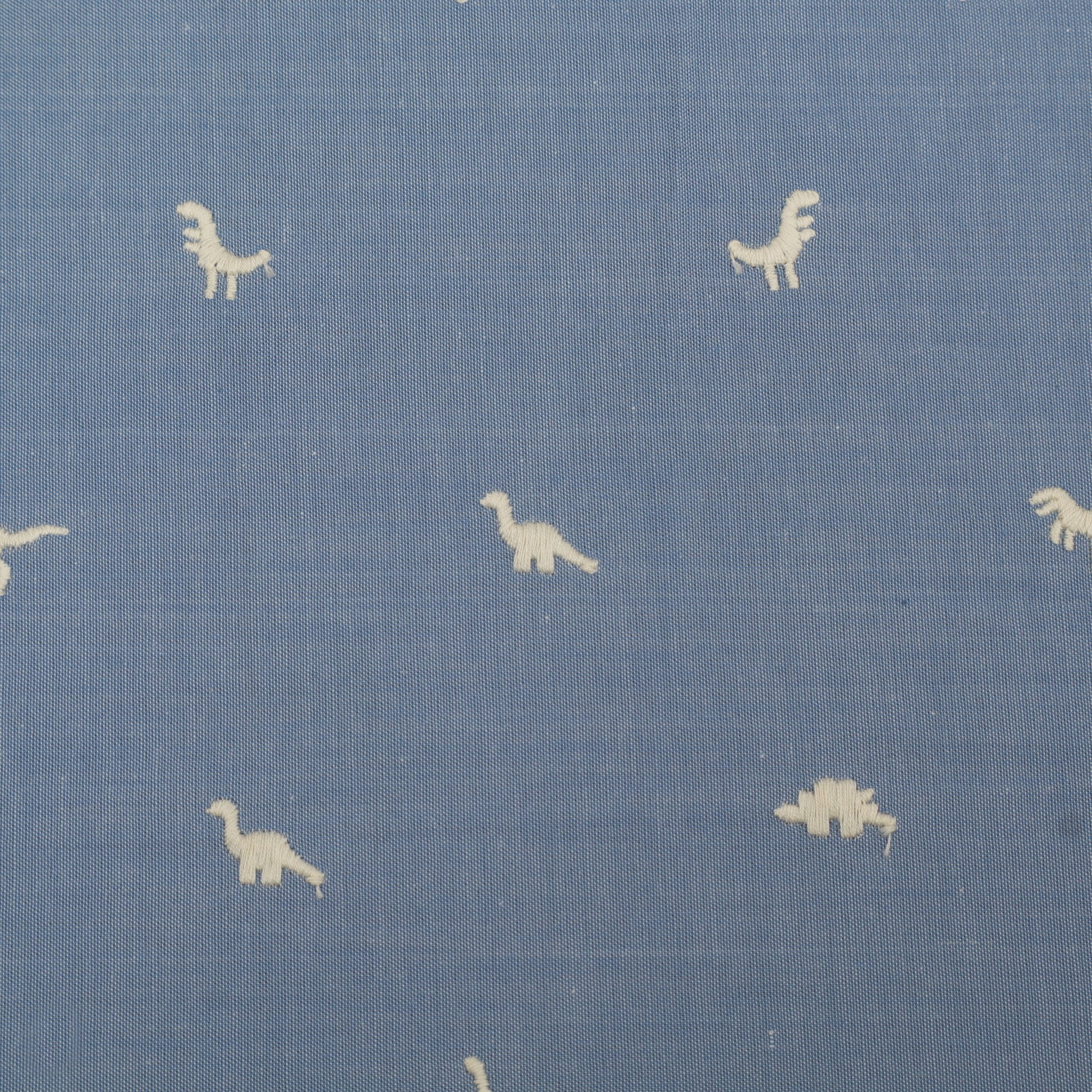 Blue fabric with small white dinosaur prints