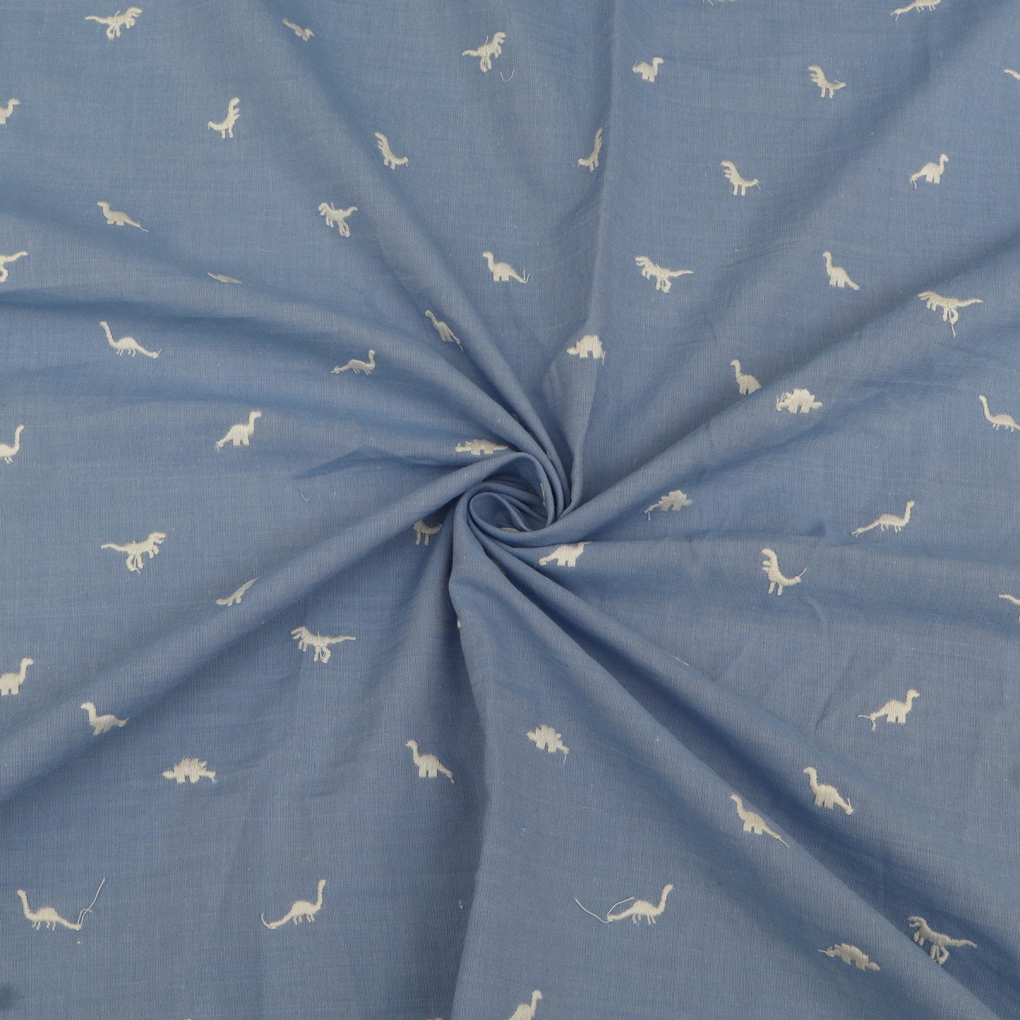 Blue fabric with white dinosaur patterns