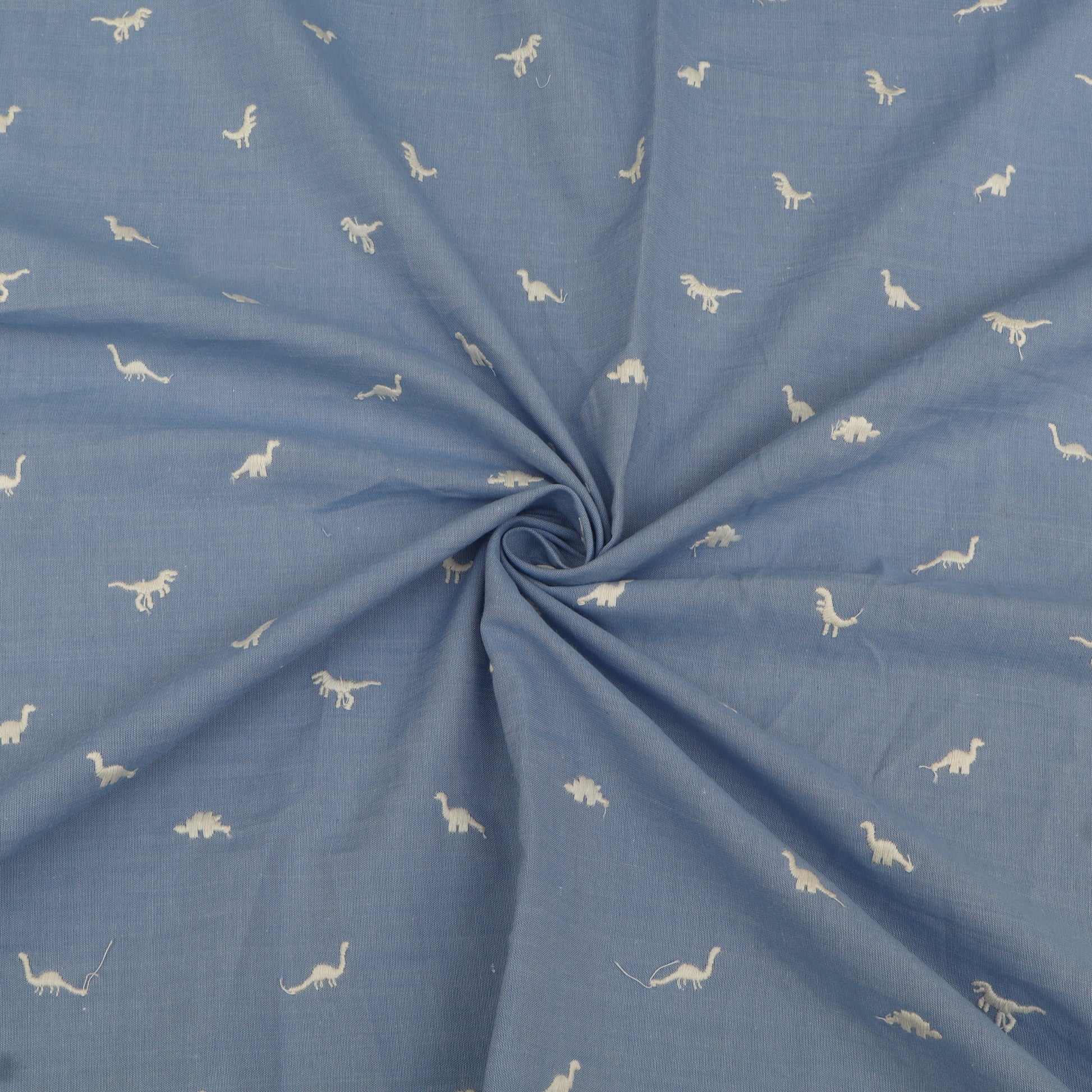 Blue fabric with white dinosaur patterns