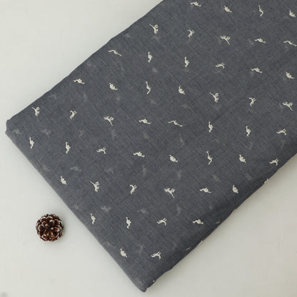 Dark gray fabric with small white patterns on a light gray background