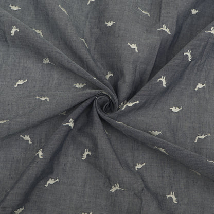 Dark gray fabric with small white patterns, rolled up