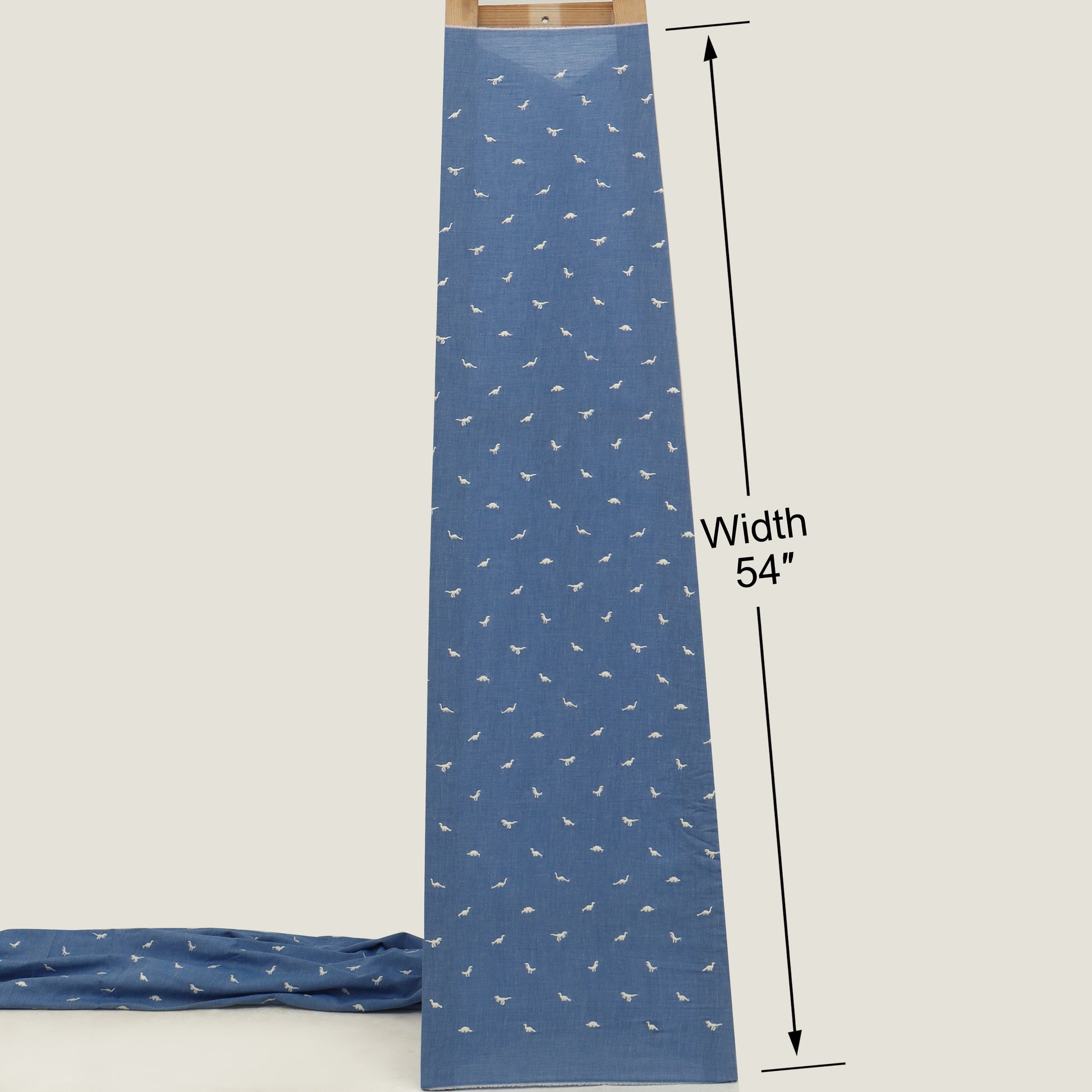 Blue fabric with white patterns and a measurement label on a white background