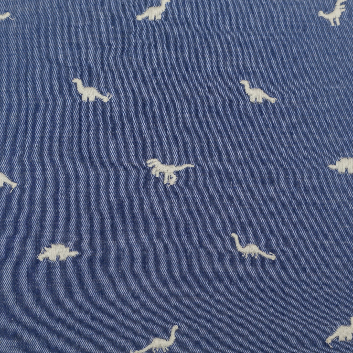 Blue fabric with white dinosaur patterns