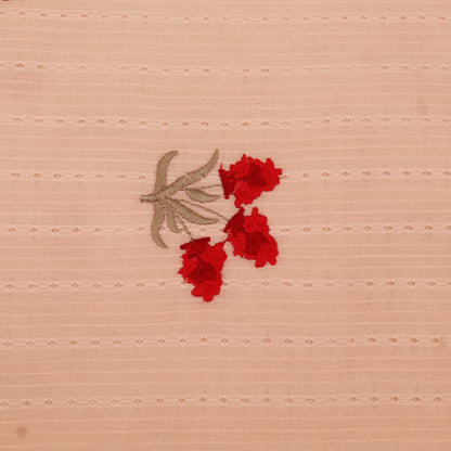 Embroidered red flowers on a beige fabric background