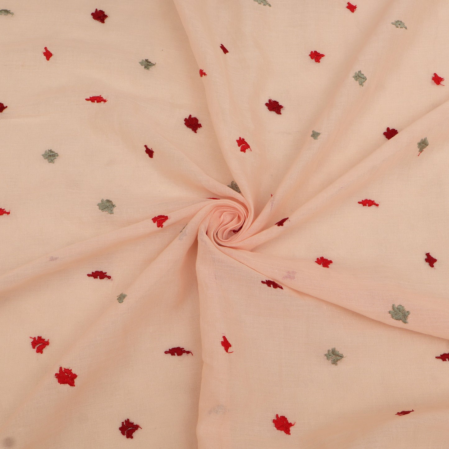 Pink fabric with small red and green floral patterns