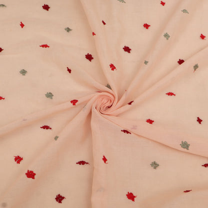 Pink fabric with small red and green floral patterns