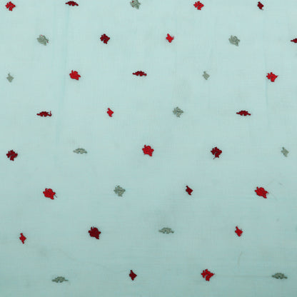 Pattern of red and green leaves on a light blue background