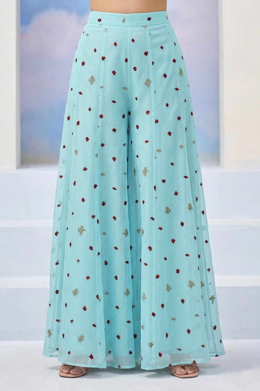 Light blue skirt with a pattern worn by a person, against a light background