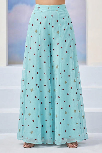 Light blue skirt with a pattern worn by a person, against a light background