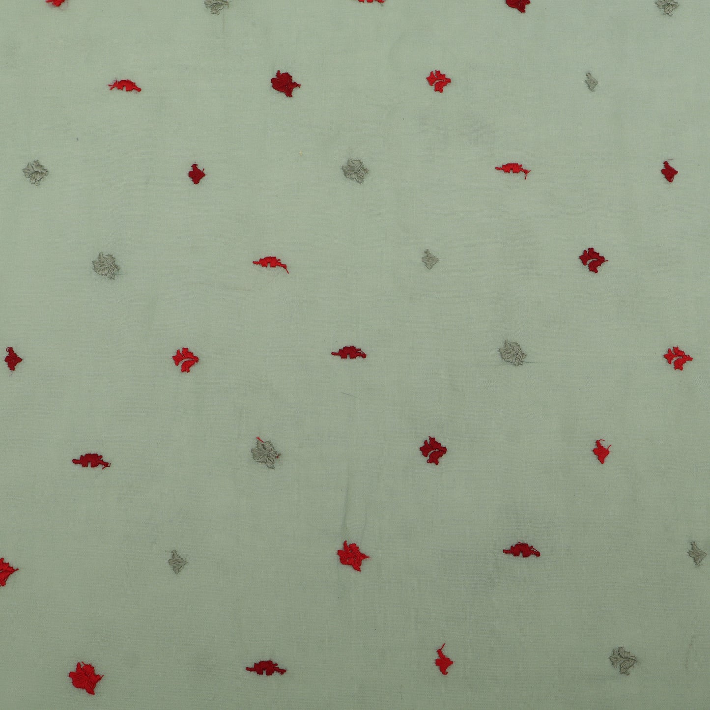 Pattern of red and gray shapes on a light green background
