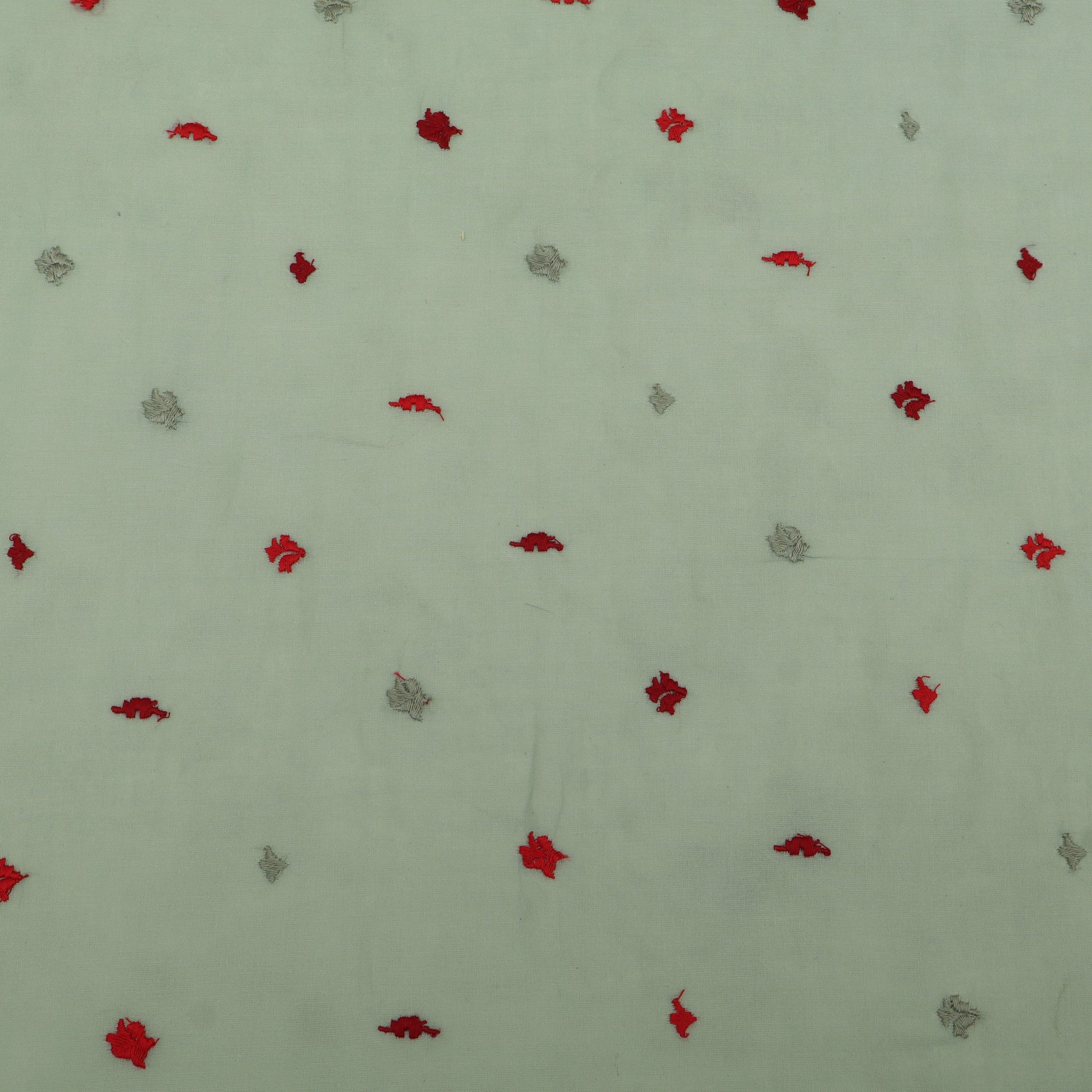 Pattern of red and gray shapes on a light green background