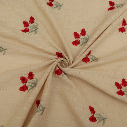 Beige fabric with red floral patterns, folded and displayed.