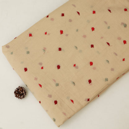 Beige fabric with small red and green patterns on a white background