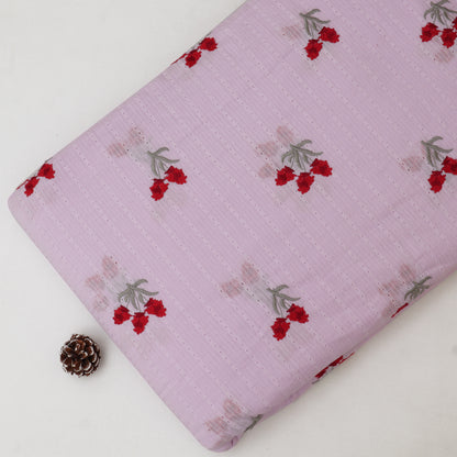 Pink fabric with red floral patterns on a white background