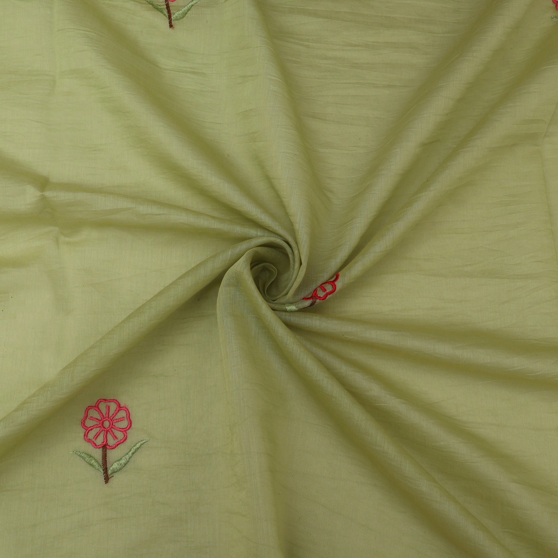 Green fabric with red floral embroidery