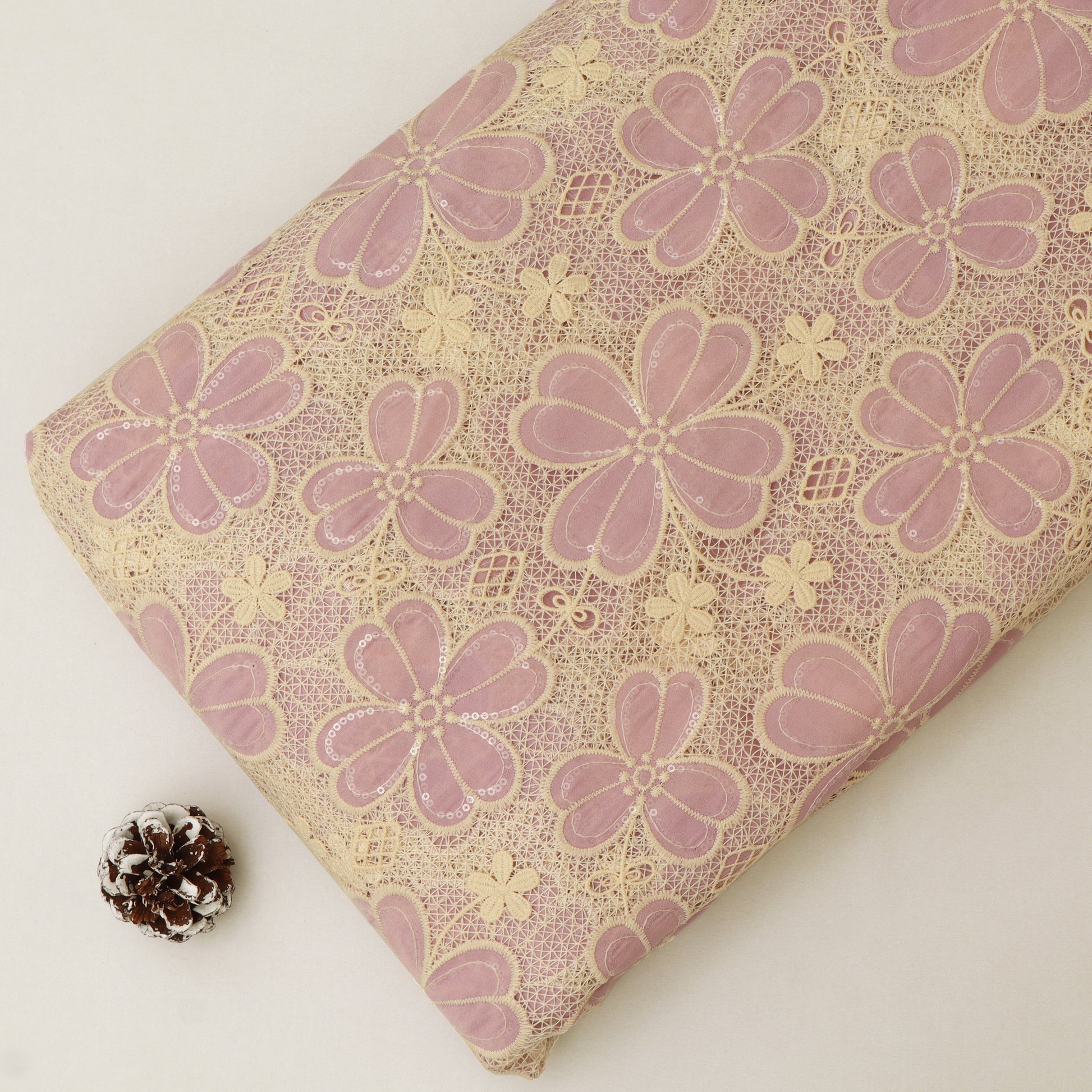 Floral-patterned fabric with pink flowers on a beige background