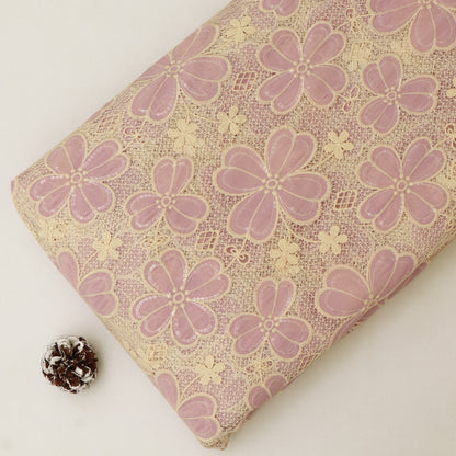 Floral-patterned fabric with pink flowers on a beige background