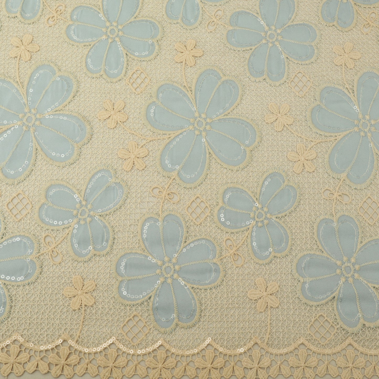 Patterned fabric with blue flowers on a beige background