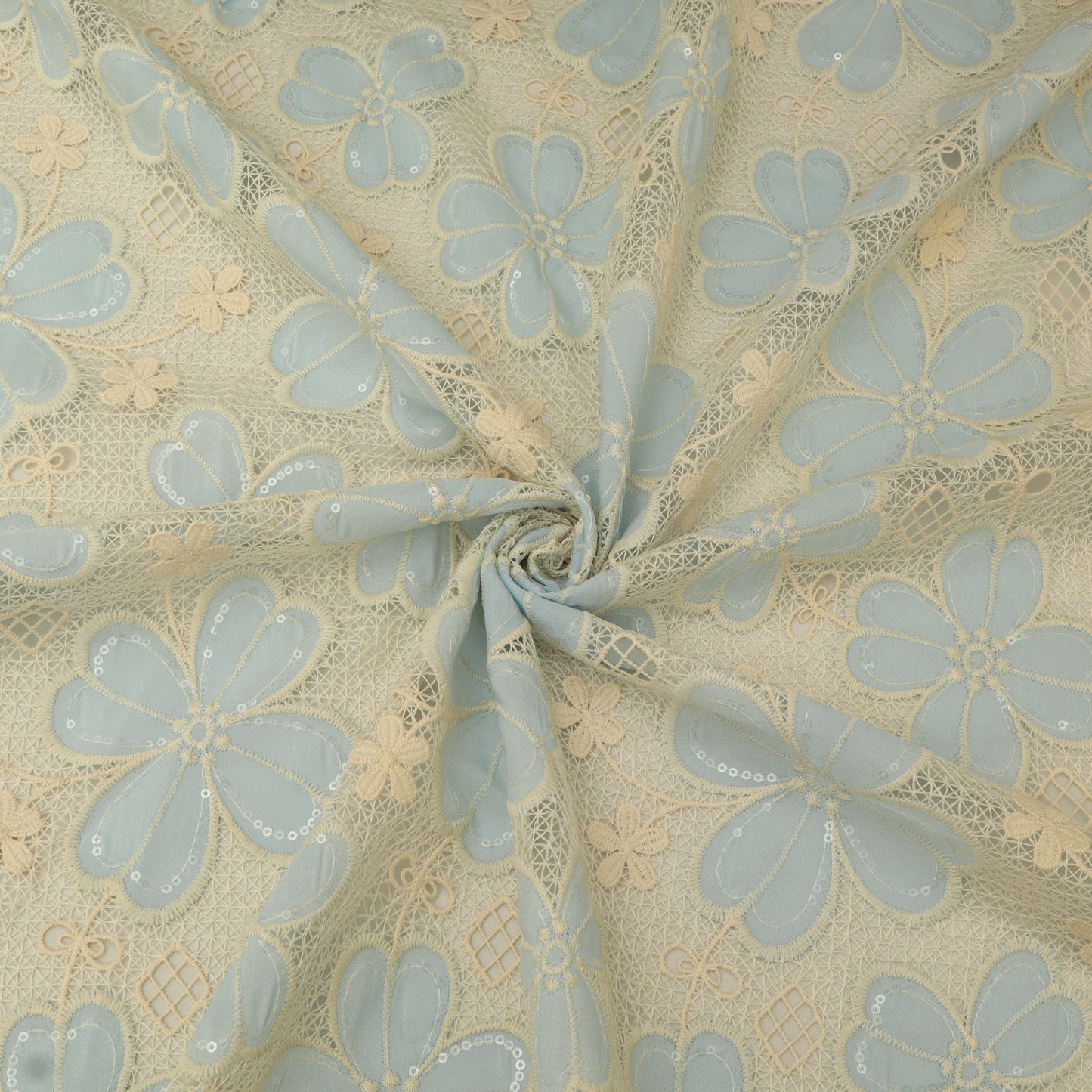 Floral lace fabric with light blue flowers on a beige background